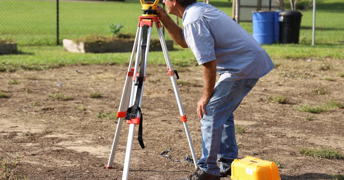 A land surveyor at work using equipment on a field in Tavares, Florida.