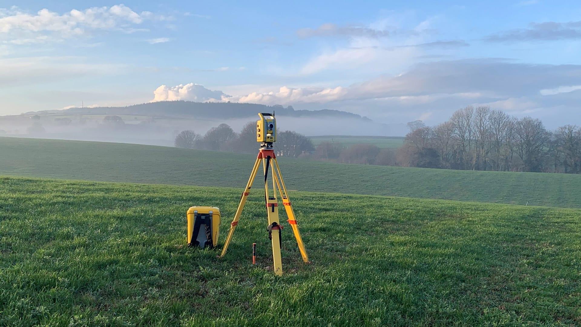 Trimble in Field With Mountains